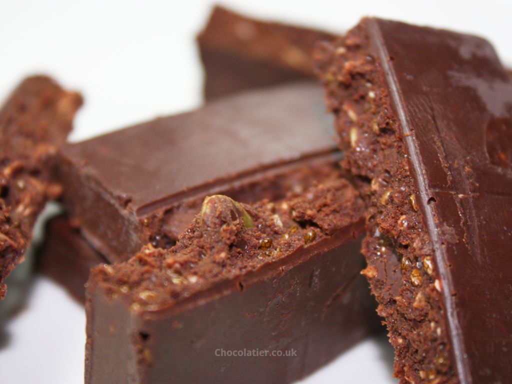 A close-up of the Conscious Organic Raw Chocolate Coconut Crunch bar