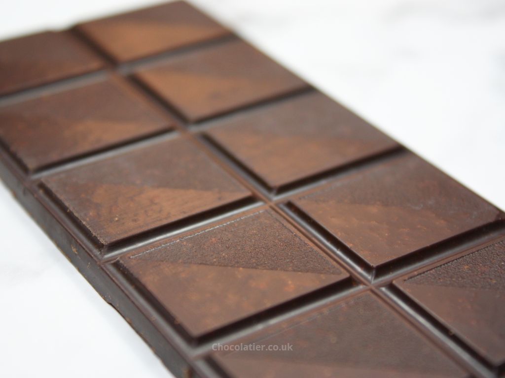 Closeup of Divine Organic 85% Rich Dark Chocolate with Turmeric & Ginger bar